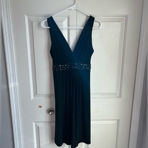B. Smart V-Neck Sleeveless Dress with Gem detailing and Tie Waist